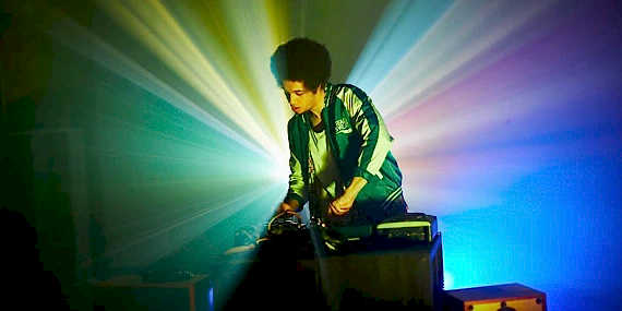 Person DJing with lights behind