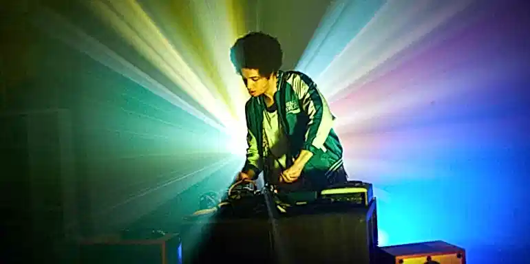 Person DJing with lights behind